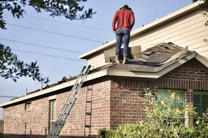Professional roofer working on a residential roof in Surf City